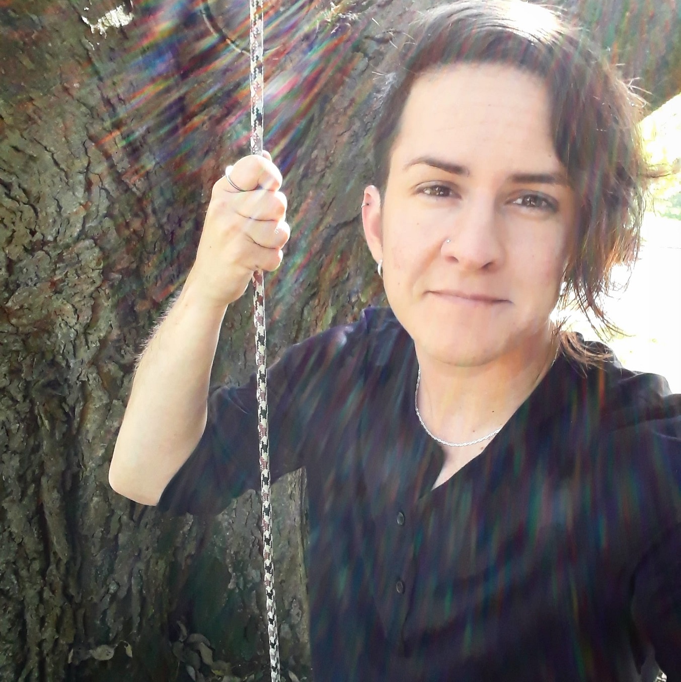 A photo of Rev. M Barclay in front of a tree.