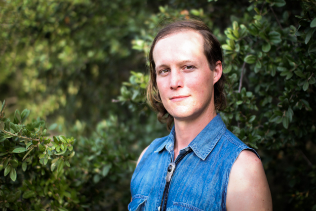 A photo of Robin Borre standing outside in front of trees